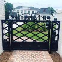 Heavy wrought iron gate with scroll top