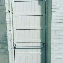 Solid aluminum privacy gate with panic hardware
