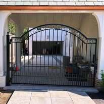Single leaf wrought iron gate with scrolls and puppy pickets