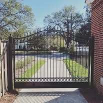 Single leaf aluminum swing gates with kick panel and royal arch top with spears