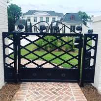 Heavy wrought iron gate with scroll top