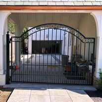 Single leaf wrought iron gate with scrolls and puppy pickets