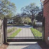 Single leaf aluminum swing gates with kick panel and royal arch top with spears