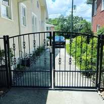 Wrought iron double leaf gates with arch top, scrolls and puppy pickets